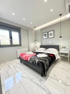 a bedroom with a large bed in a room at BlueLine apartment 1 in Loutraki