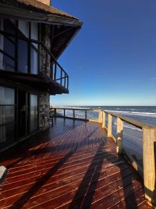 a building on the beach with the ocean in the background at La Proa in Aguas Dulces