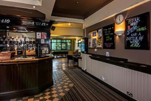 a bar in a restaurant with a counter at The Miners Arms in Leeds