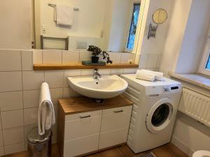 een badkamer met wastafel en wasmachine bij Rosenberger I in Hopfgarten im Brixental