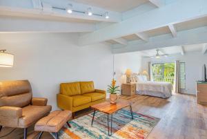 a living room with a couch and a bed at Puamana 26B in Princeville +25 photos