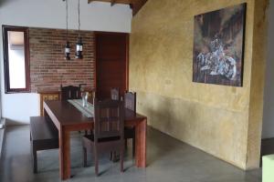 a dining room with a wooden table and chairs at Mount Bliss Home Stay in Mount Lavinia