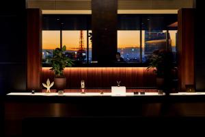 a counter with plants and a window in a restaurant at Park Hotel Tokyo in Tokyo