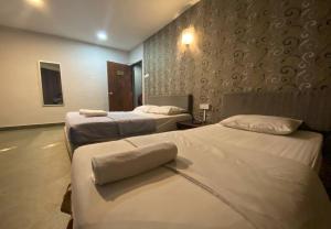 Voodi või voodid majutusasutuse Hotel Harbour Inn toas