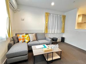 a living room with a couch and a table at Casa Stella 8 by Liaison カーサステラ8 byリエゾン in Osaka