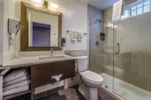 a bathroom with a toilet and a sink and a shower at Hotel 414 Anaheim in Anaheim