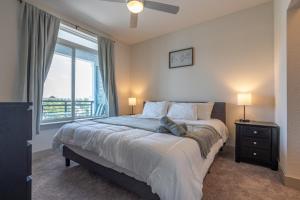 a bedroom with a large bed and a window at Top Floor City Views! King Bed Pool Gym Free Parking in San Antonio +42 photos