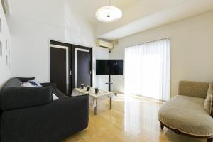 a living room with a couch and a table at -華 HANA- Vacation Rental in Nagoya