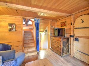 a living room with wooden walls and a tv and a couch at Chalet cosy proche du centre de Morzine avec parking - FR-1-524-131 in Morzine