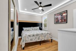 a bedroom with a bed and a ceiling fan at Ocean Lakes Walk to beach! Waterpark! Arcade! Dogs Welcome! in Myrtle Beach +28 photos