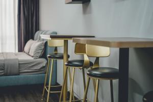 a room with stools and a table and a bed at Tun Aminah Shoplot 10-15pax KTV Mahjong Funhouse by Our Stay in Skudai +35 photos