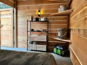 a room with wooden walls and a room with shelves at Butterfly Cottage - open air eco villa in Oliver
