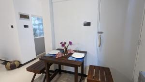 a room with a table with flowers on it at Top view villa in Dickwella