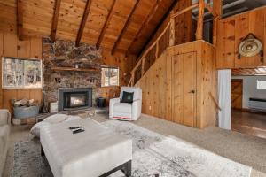 ein Wohnzimmer mit Couch und Kamin in der Unterkunft The Fawnskin Hideaway, HUGE Backyard, BBQ & Patio! in Fawnskin