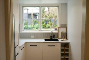 a kitchen with a sink and a window at Carinya Charming Newstead home in Newstead
