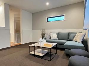 a living room with a couch and a table at Casa Stella 10 by Liaison in Osaka