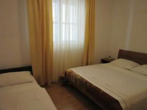 Posteľ alebo postele v izbe v ubytovaní Petar Apartments