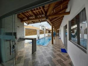 an indoor pool in a house with a wooden ceiling at Casa Lua in Prado
