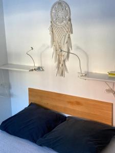 a dream catcher hanging on a wall above a bed at L'appart de Serre Che in La Salle Les Alpes