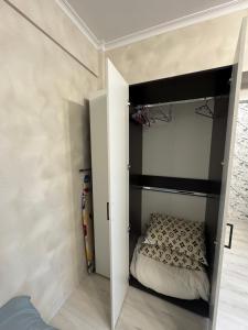 a small bedroom with a bed in a room at Apartment in Airport in (( Turksib ))
