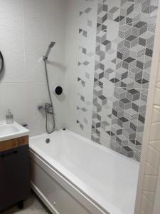 a bathroom with a white tub and a shower at Apartment in Airport in (( Turksib )) +20 photos