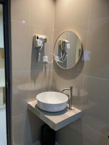 a bathroom with a sink and a mirror at Kawi Jaya Hotel in Nagoya +35 photos