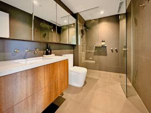 a bathroom with a toilet and a sink and a shower at 1 Bedroom Apartment With Parking Close To Beach in Williamstown