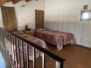 ein Zimmer mit zwei Betten und einem Treppengeländer in der Unterkunft Charming House in Vittoria in Vittoria