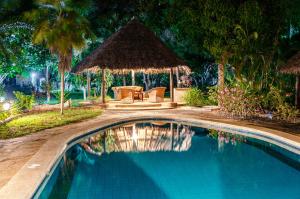 a swimming pool in front of a resort at night at Kipembeni 'Grounding' in Kilifi