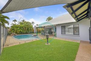 a house with a swimming pool and a yard at Cityside Hideaway 4BR Family House - Pool - Markets in Paraparap