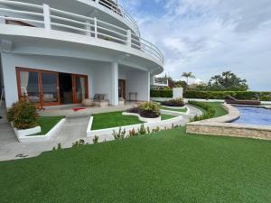 a house with a swimming pool and a yard at Amed Sea Resort in Amed