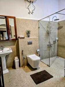 a bathroom with a shower and a toilet and a sink at Milhaven Crest in Kodaikānāl +38 photos