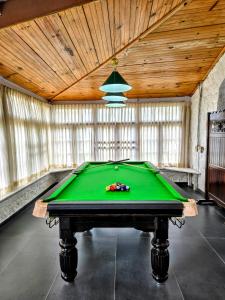 a pool table in a room with a ceiling at Milhaven Crest in Kodaikānāl