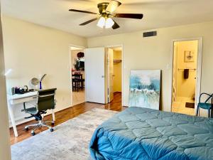 a bedroom with a bed and a desk and a ceiling fan at Medical Center Rice Village Condo in Houston +41 photos