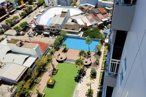 an aerial view of a city with a swimming pool at Relaxing Studio at Vida View Makassar Apartment By Travelio in Pampang
