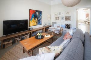 a living room with a couch and a tv at Postmaster's Chamber in Ekenäs