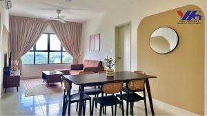 a living room with a table and chairs in a room at Arena Residence KLIA Sepang With Netflix in Sepang