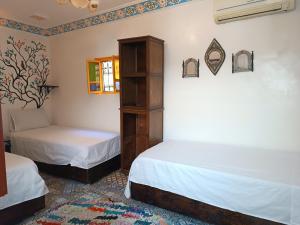 Postel nebo postele na pokoji v ubytování Riad Safir Fes Deluxe