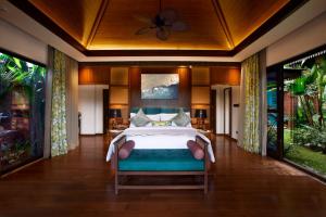 a bedroom with a bed in a room with windows at The Leela Coorg Forest Sanctuary in Madikeri +54 photos