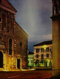 an old church and two buildings next to a building at La Casa Di Fernanda in Belluno