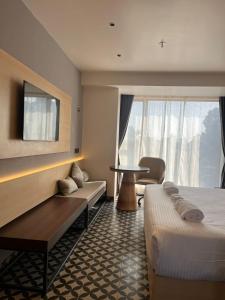 a hotel room with two beds and a table at Hotel Four Natives in Tinsukia