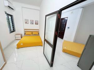 a room with two beds and a mirror at 46 An Hòa, Mỗ lao in Hanoi