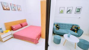 a bedroom with a bed and a couch and a table at 46 An Hòa, Mỗ lao in Hanoi +1 photo