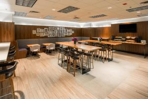 a dining room with wooden tables and chairs at Kinzie Hotel in Chicago