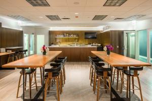a large kitchen with wooden tables and stools at Kinzie Hotel in Chicago