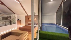a house with a swimming pool in the middle of a room at La Vida Villa in Bārsiv