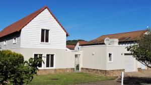a white house with a red roof at Seaside at The Dunes in Plettenberg Bay