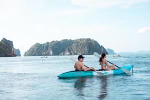 a man and woman sitting on a kayak in the water at TreeHouse Villas Koh Yao - Adults Only in Ko Yao Noi