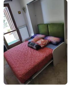 a bed with two pillows on top of it at Nella dolce Grotta in Monsummano Terme