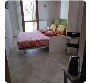 a bedroom with a bed with red sheets and a window at Nella dolce Grotta in Monsummano Terme